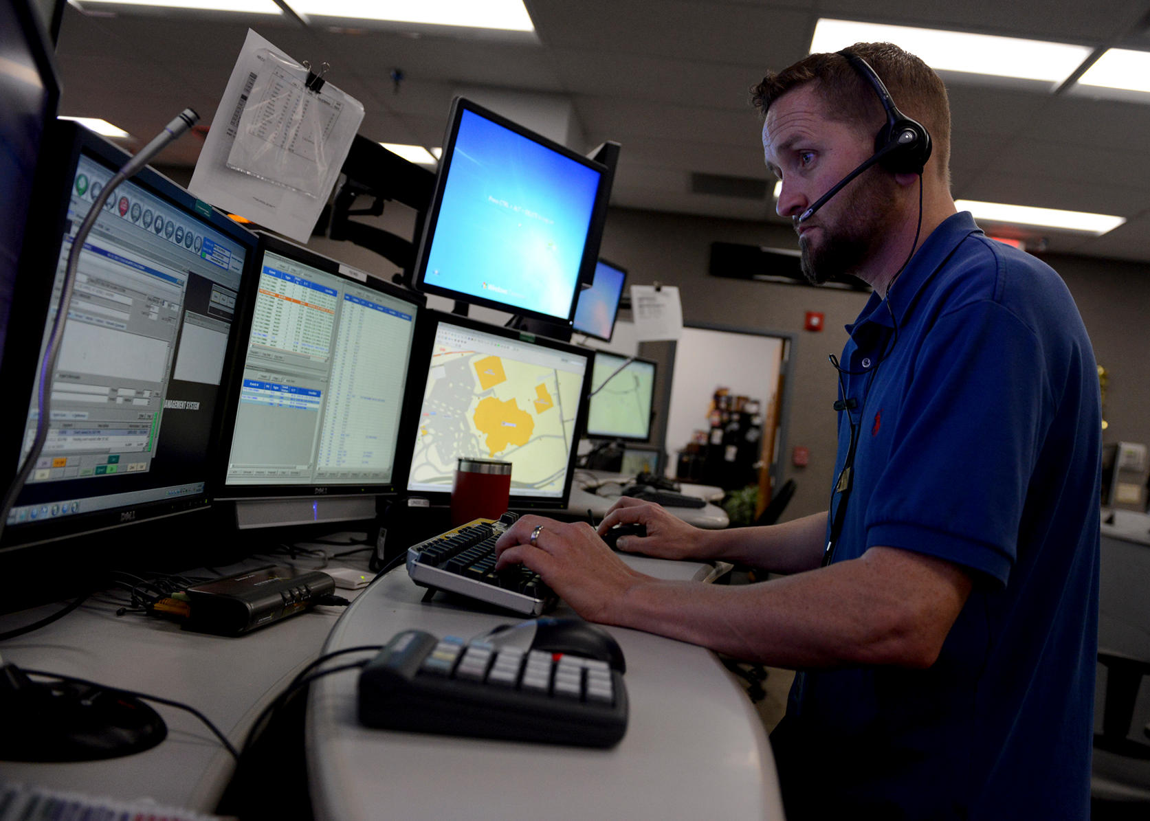 Fla. (April 12, 2017) Jason Solomon, a Navy Region Southeast 911 emergency dispatcher, works at his multiscreen station in the Navy Region Southeast Regional Dispatch Center. The RDC currently dispatches fire and security personnel for 14 installations.